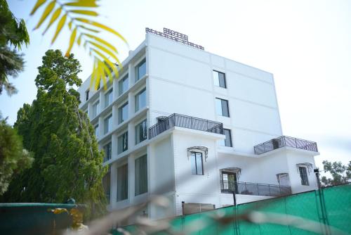 a white building with balconies on the side of it at HOTEL MAKHAN VIHAR in Ambikāpur