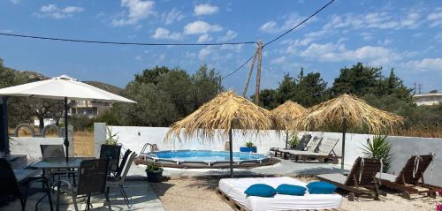 a patio with a table and chairs and a pool at EnjoyRhodes Villa near Faliraki in Kalithies