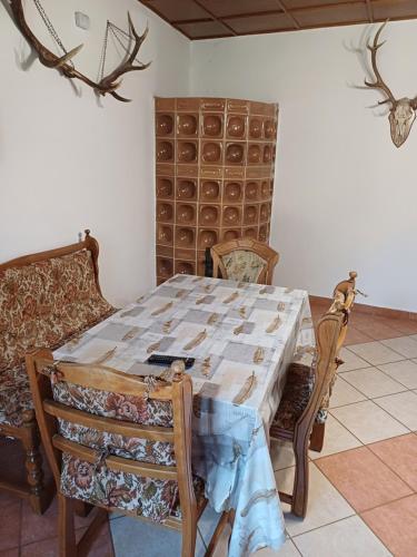 a dining room with a table and two chairs at Zanati Apartmannház in Nagykapornak