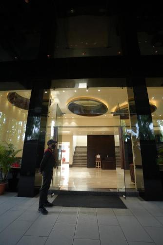 a person standing in front of a building at HOTEL MAKHAN VIHAR in Ambikāpur