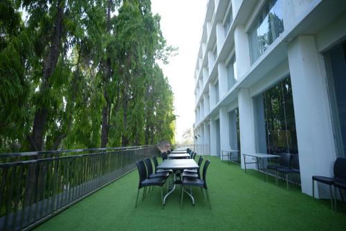 a table and chairs on the balcony of a building at HOTEL MAKHAN VIHAR in Ambikāpur