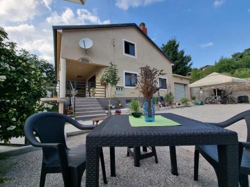 a table and chairs in front of a house at Haus Natura in Jurdani