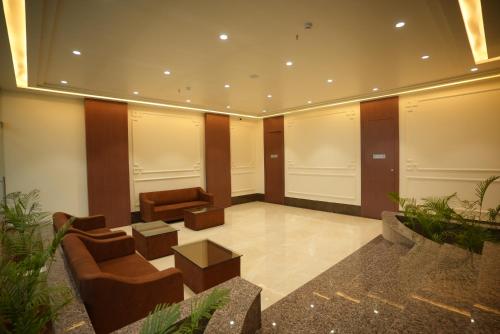a lobby with a couch and a chair in a building at HOTEL MAKHAN VIHAR in Ambikāpur