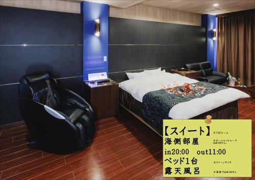 a hotel room with a bed and a black chair at Hotel 4Season in Miyazaki