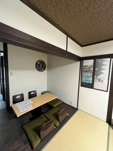 a room with a table and chairs in it at Kaga House in Kanazawa