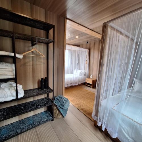 a room with a bedroom with a bed and a window at Elephant lodge in Kwa Kuchinia