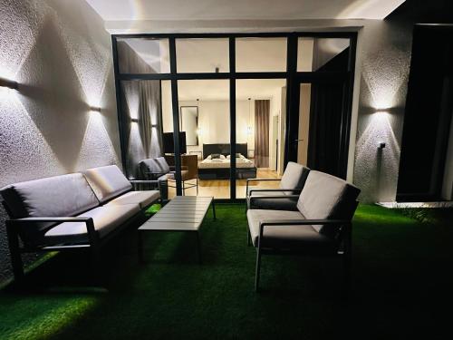 a living room with two couches and a room with a bedroom at Nature Nook in Eşelniţa