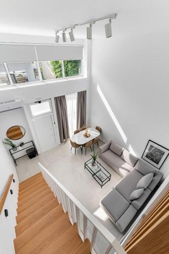 an overhead view of a living room with a couch and a table at Calliope luxury loft with backyard in Ierapetra