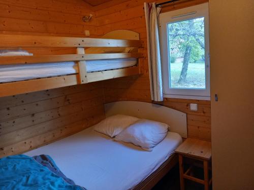 - un petit lit dans une cabine avec fenêtre dans l'établissement Domaine de la Chêneraie, à Mirabel
