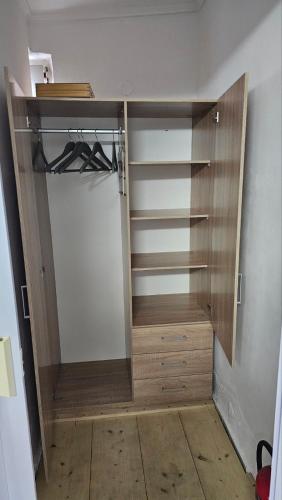 a walk in closet with wooden doors and shelves at Sea Side View in Dhíkella