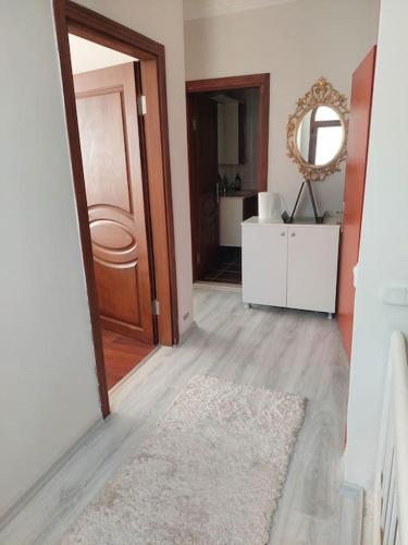 a hallway with a door and a rug and a mirror at Şifne yalı'da 4 oda 9kisi yatak kapasite manzaralı in Cesme
