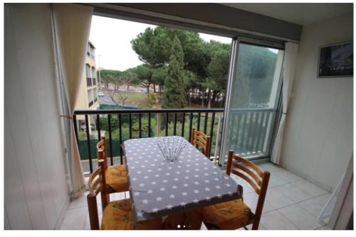 une table et des chaises sur un balcon avec vue dans l'établissement Studio Cabine 4 pers Cap d'Agde avec loggia, au Cap d'Agde