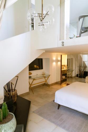 a large white bedroom with a bed and a table at Villa Marina Capri in Capri