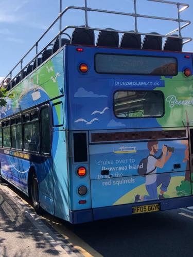 a blue bus with an advertisement on the back at The Mariners Guest House in Poole