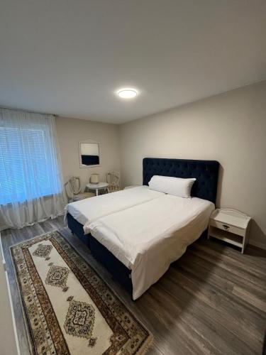 a bedroom with a large bed and a window at Köpingebro in Köpingebro