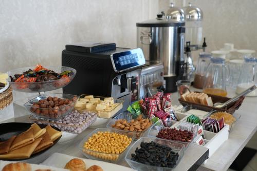 a table with many different types of food on it at Hotel Samaria Terrace in Samarkand