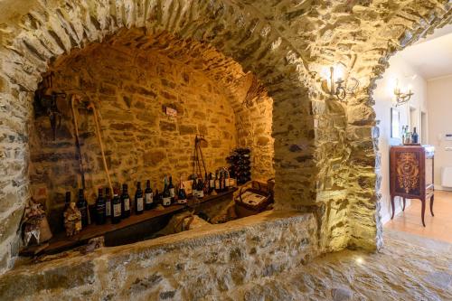 a stone wall with a bunch of wine bottles at Palazzo Gargano in Prignano Cilento