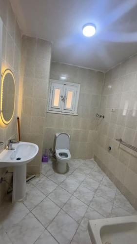 a bathroom with a toilet and a sink at Panoramic see view apartment in North Coast الساحل الشمالي in Alexandria