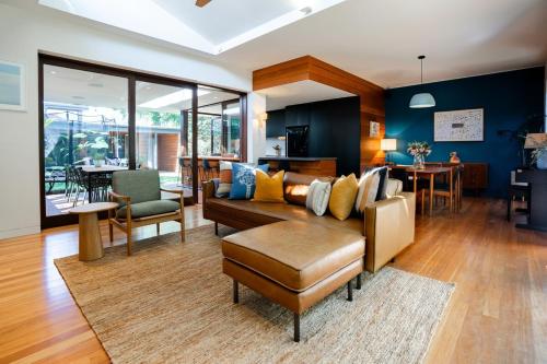 a living room with a couch and a table at Villa Catherine - 3BR Lilyfield in Sydney
