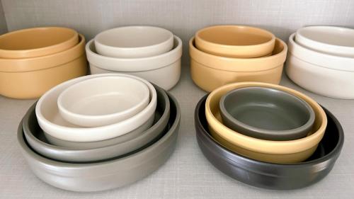 a group of different colored bowls in a drawer at Gwangan Neogeo House in Busan