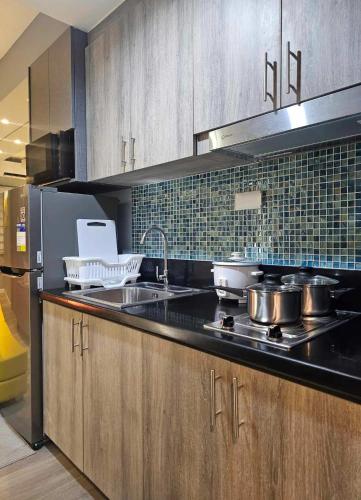 a kitchen with pots and pans on the counter at S Residences Luxury Unit in Manila