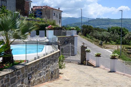 a house with a swimming pool on a stone wall at Palazzo Gargano in Prignano Cilento
