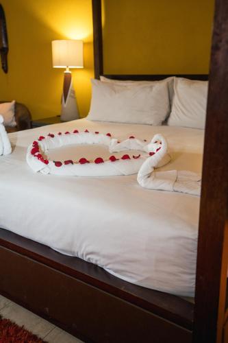 a bed with a snake made out of towels at Riverstone Lodge in Muldersdrift
