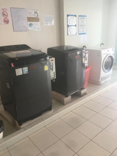 a row of trash cans sitting on display in a store at Studio Seaview Jomtien floor12 23sqm in Jomtien Beach