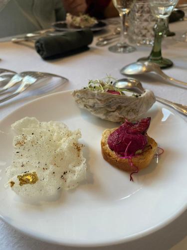 a white plate with food on a table at Maison Georges in Tourcoing