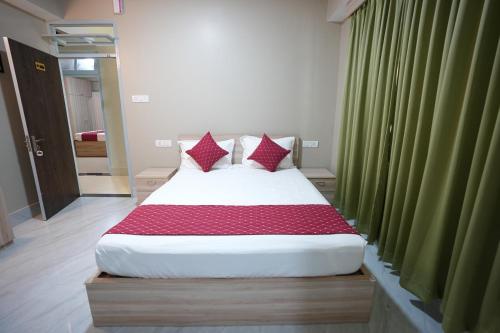 a large bed in a room with green curtains at TheMapleVillageFarmstay in Gangtok