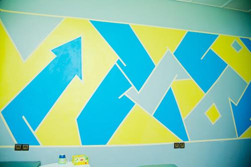 a bathroom with a colorful mural on the wall at Parakou's Paradise in Parakou