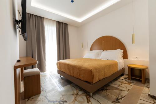 a hotel room with a bed and a window at Maggiano Boutique Hotel in Peschici
