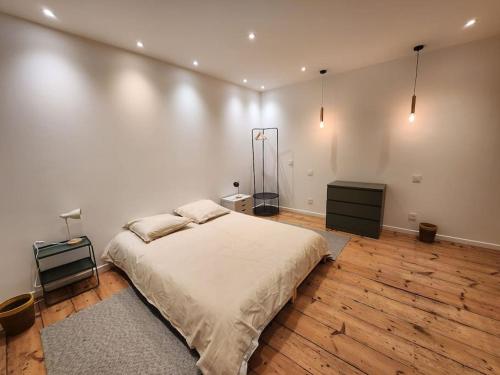 a bedroom with a large bed and two night stands at La Villa Ausone in Saint-Jean-dʼAngély