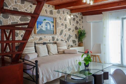 a bedroom with a bed and a glass table at Wisteria Apartments in Karterados