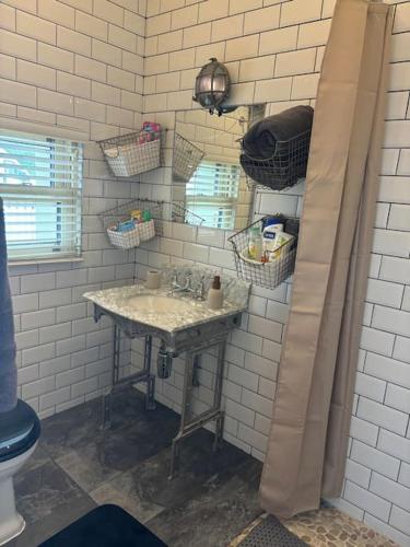 a bathroom with a sink and a mirror at Beautiful Seaside Cottage Wicklow town in Wicklow