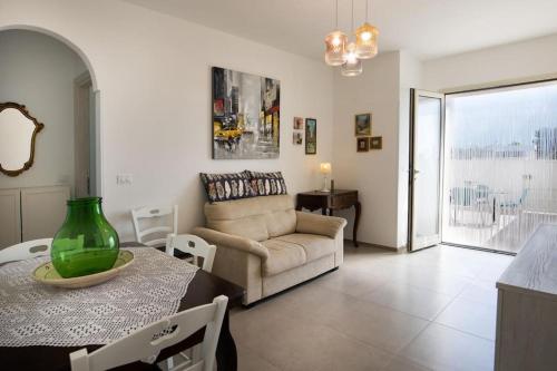 un soggiorno con un divano e un tavolo di Casa Relax Torre Pali a Torre Pali