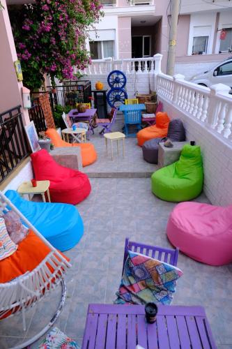 a group of colorful chairs and tables on a patio at Yeşim Pansiyon in Cesme
