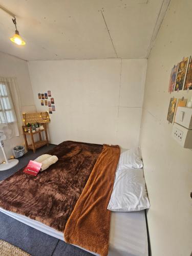 a bedroom with a large bed in a room at Panakluea at Kokuang Homestay in Ban Na Lae