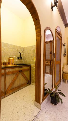 an archway in a kitchen with a counter and a sink at Aavya Wellness Retreat Center in Rishīkesh