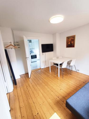 Una sala de estar con una mesa y sillas y un televisor. en 1 Bedroom Apartment In Frederikshavn City With Free Parking, en Frederikshavn