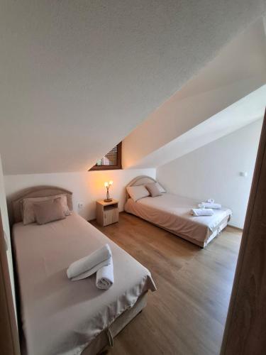 a bedroom with two beds in a attic at Chalet LENA & One Bedroom Apartment Lena in Žabljak