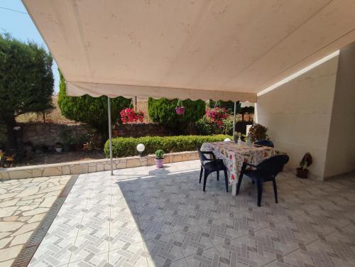 a patio with a table and chairs on a patio at Villa Sidorela in Ksamil