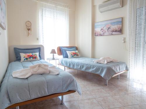a bedroom with two beds with towels on them at Rena's House in Ierapetra