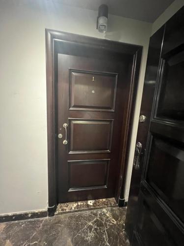 a brown door in a room with at Panorama studio in the heart of heliopolis, cairo in Cairo