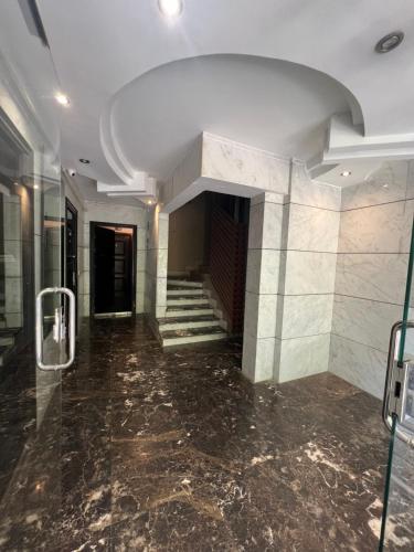 a hallway of a building with a marble floor and stairs at Panorama studio in the heart of heliopolis, cairo in Cairo