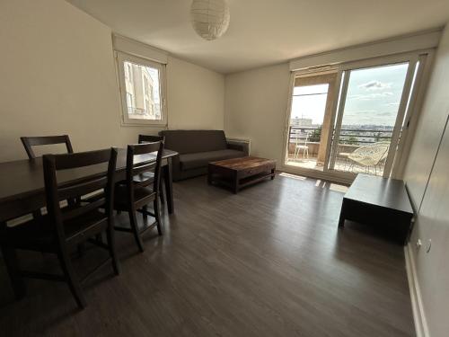 un salon avec une table et un canapé dans l'établissement A 500m Paris, 130m2 avec 4ch, balcon et parking, au Kremlin-Bicêtre