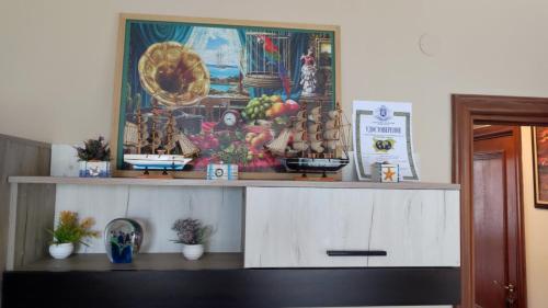 a shelf with a painting on top of it at Jacky's Apartament - Апартамент в Свети Влас in Sveti Vlas