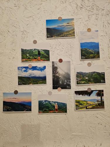 a bunch of pictures hanging on a wall at Panakluea at Kokuang Homestay in Ban Na Lae