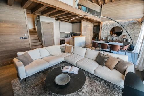 un salon avec un canapé blanc et une table dans l'établissement Appartement aux pieds des pistes, à Saint-Étienne-de-Tinée