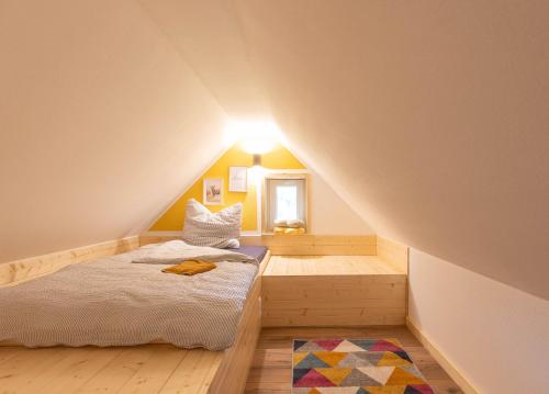 a small bedroom with a bed in a attic at Urlaub am Schwarzbach mit Sauna und Whirlpool Haus Felix in Küchelscheid